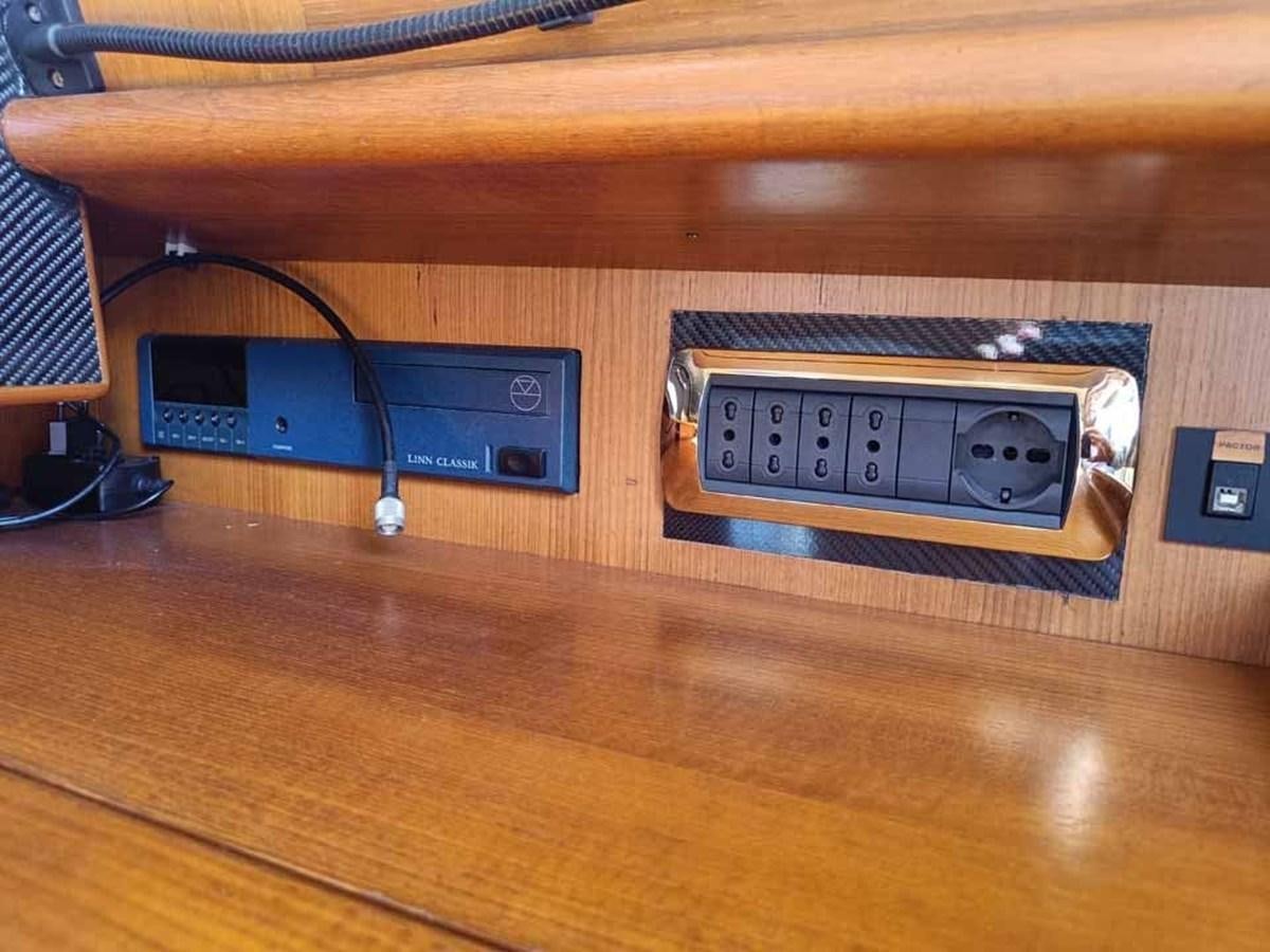 a couple of electronic devices on a table aboard PLUM Yacht for Sale