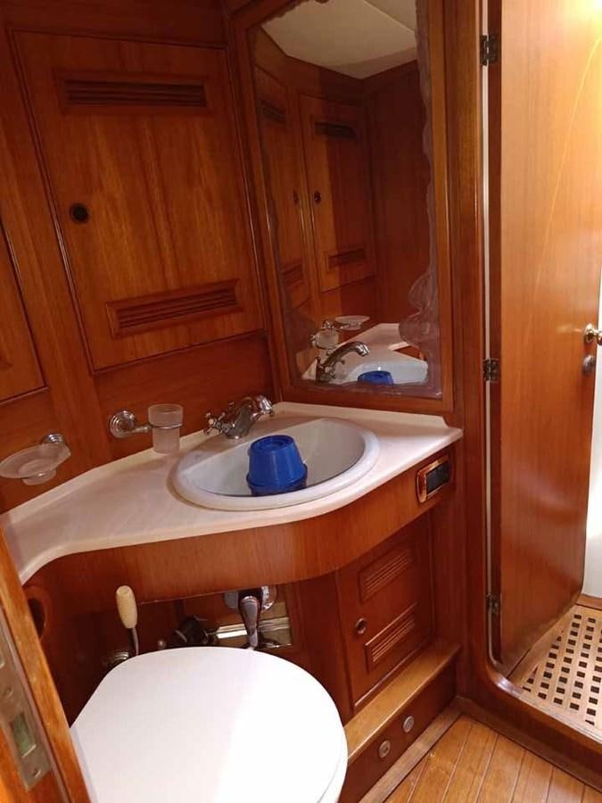 a bathroom with a sink and a mirror aboard PLUM Yacht for Sale