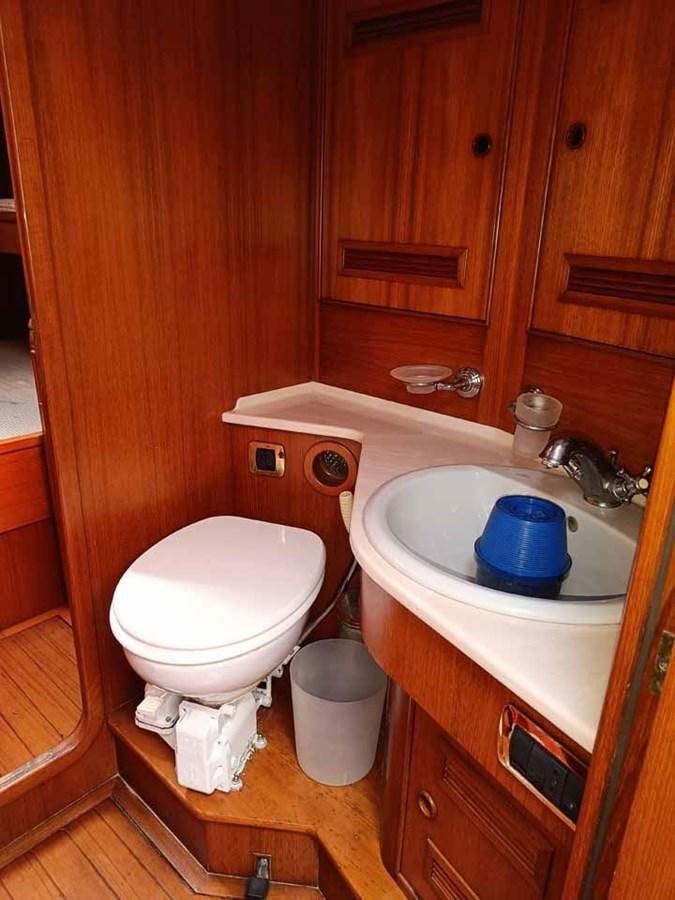 a toilet and sink in a bathroom aboard PLUM Yacht for Sale