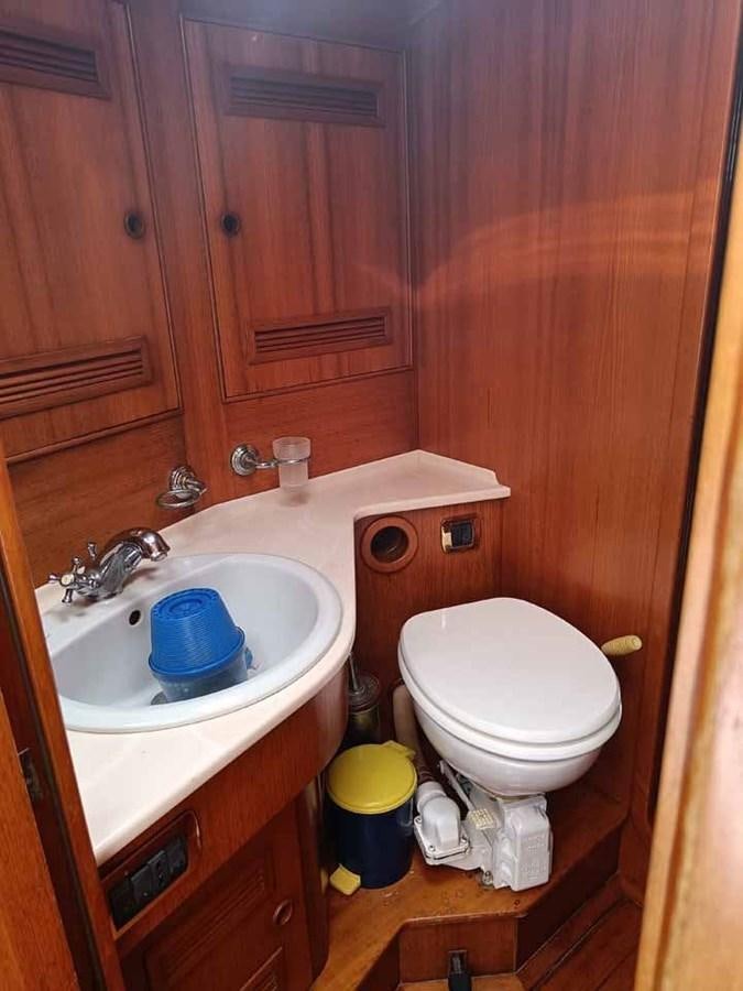 a toilet and sink in a bathroom aboard PLUM Yacht for Sale