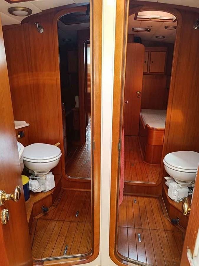 a bathroom with a toilet and a sink aboard PLUM Yacht for Sale