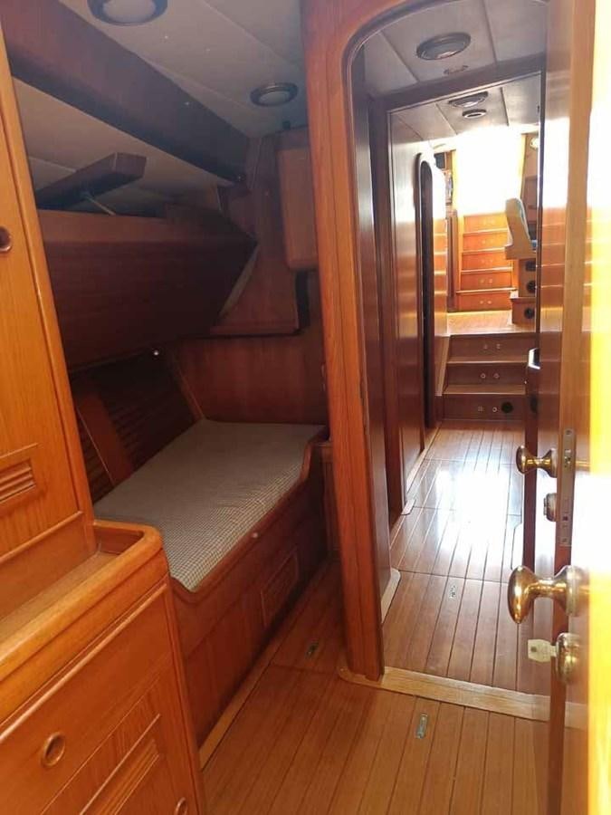 a room with a wood door and a mirror aboard PLUM Yacht for Sale