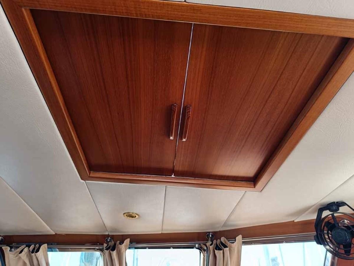 a wooden cabinet with a door aboard PLUM Yacht for Sale