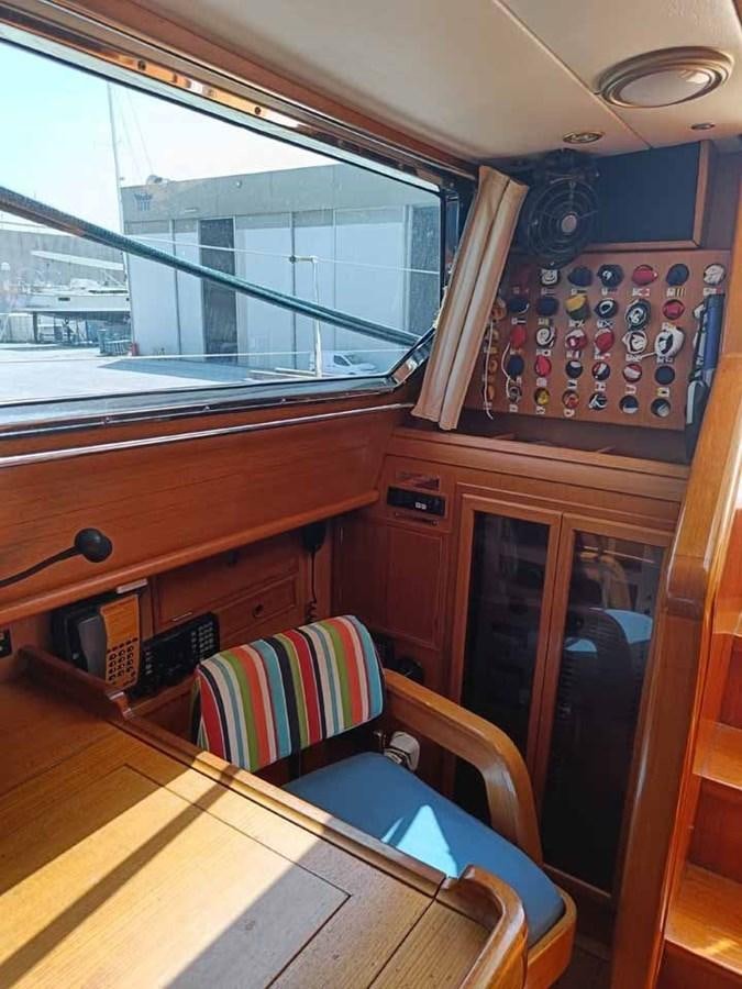 a room with a chair and a window aboard PLUM Yacht for Sale