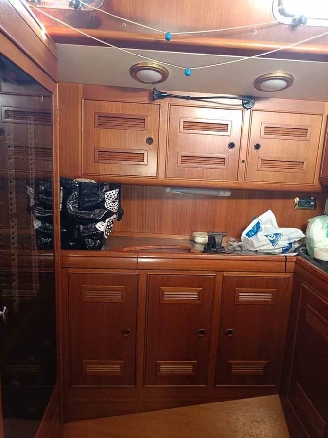 a kitchen with wooden cabinets aboard PLUM Yacht for Sale