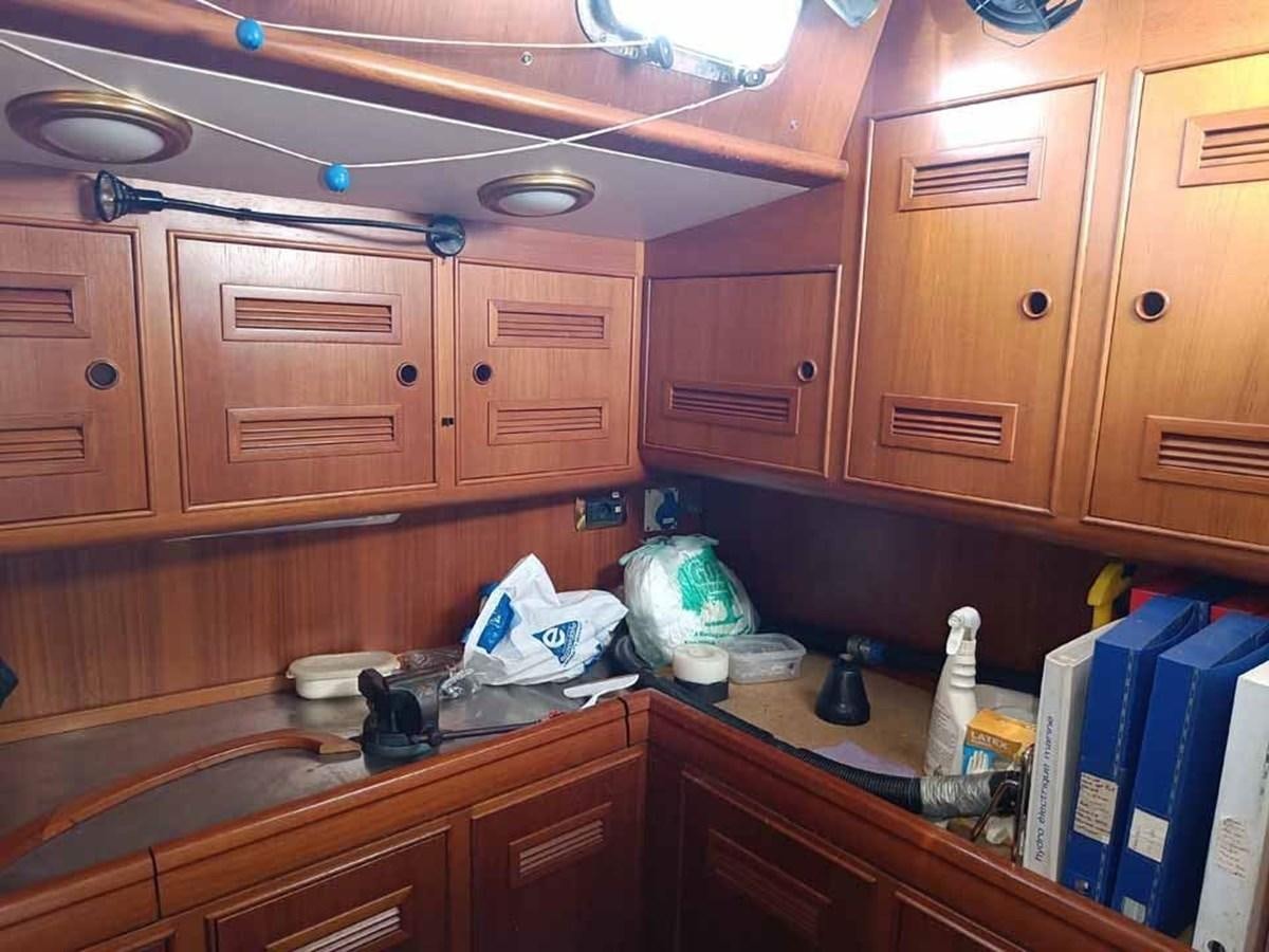 a kitchen with wooden cabinets aboard PLUM Yacht for Sale