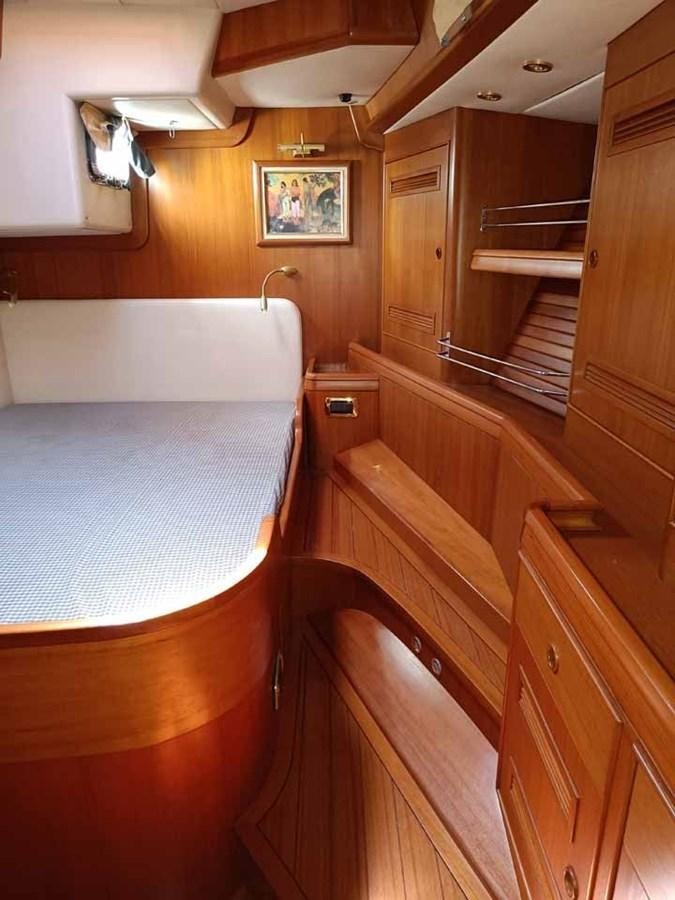 a bathroom with wooden cabinets aboard PLUM Yacht for Sale