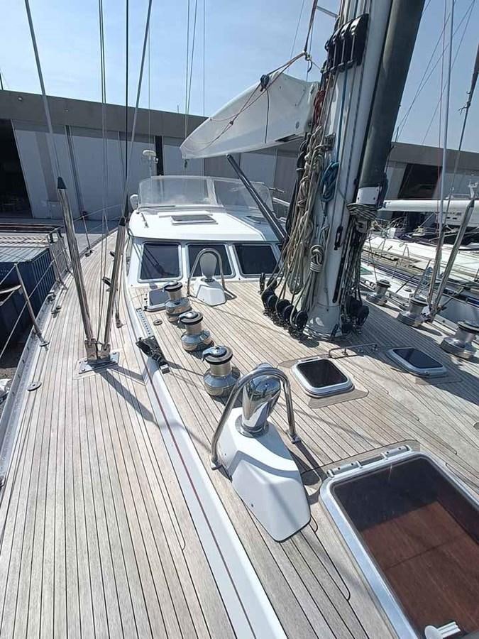 a deck with a boat and a deck with a railing aboard PLUM Yacht for Sale