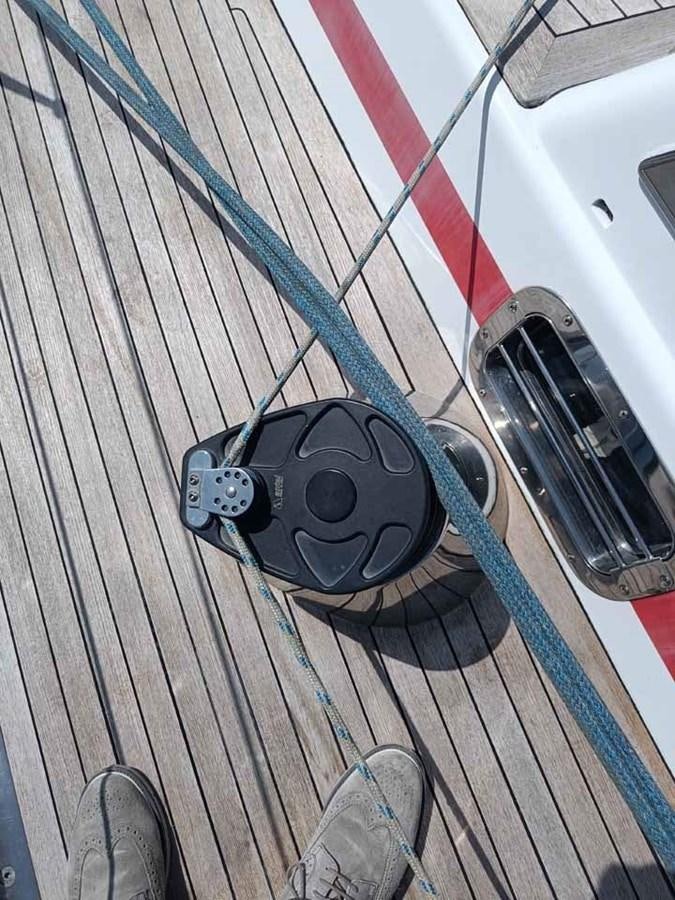 a black speaker on a wooden floor aboard PLUM Yacht for Sale