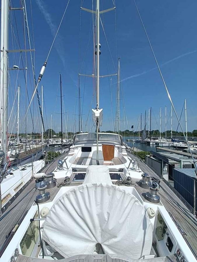 a large white boat in a harbor aboard PLUM Yacht for Sale