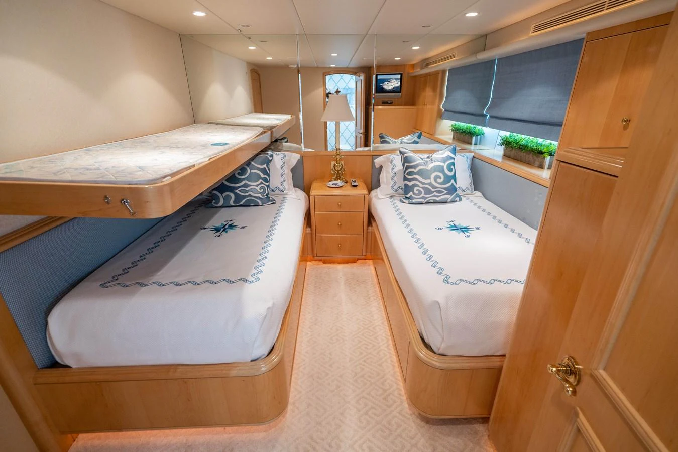 a room with beds and a window aboard HOG HEAVEN Yacht for Sale