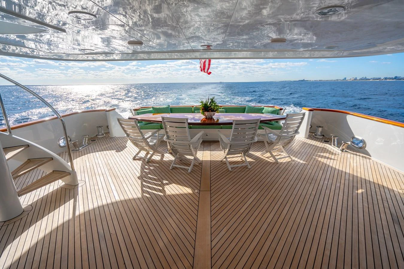 a deck with a table and chairs on it aboard HOG HEAVEN Yacht for Sale