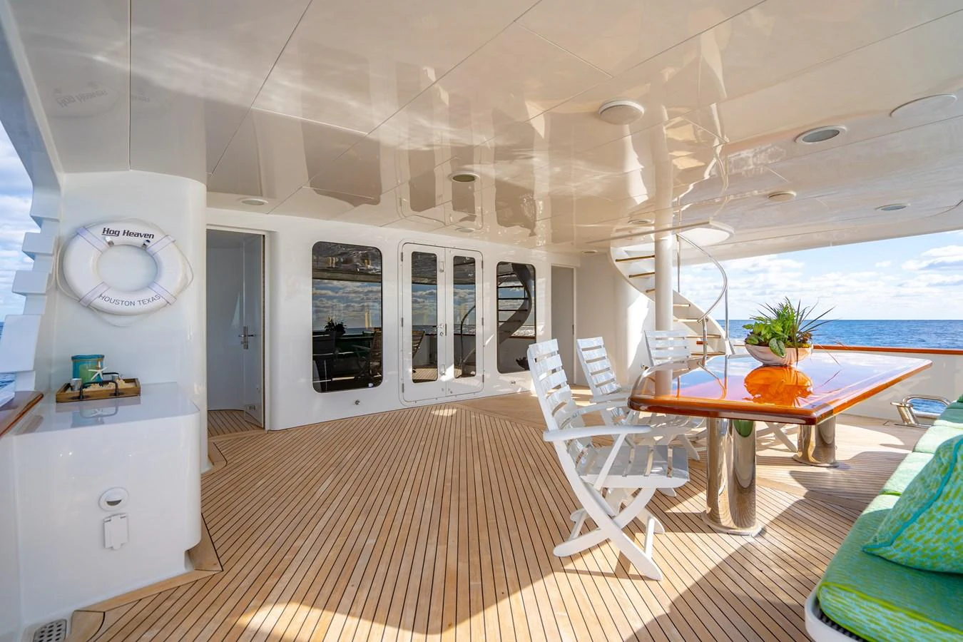 a room with a table chairs and a large window aboard HOG HEAVEN Yacht for Sale