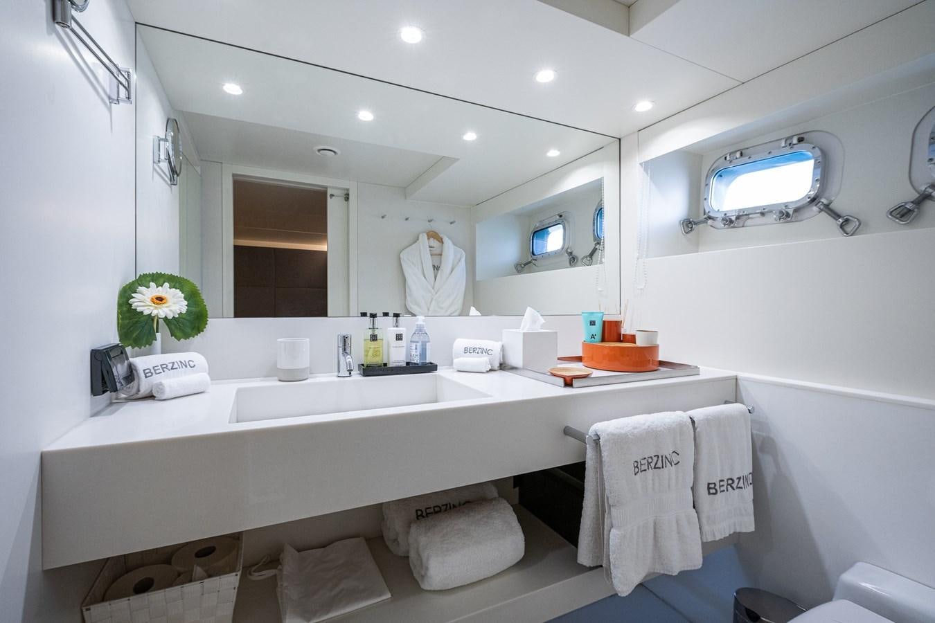 a bathroom with a large mirror aboard BERZINC Yacht for Charter