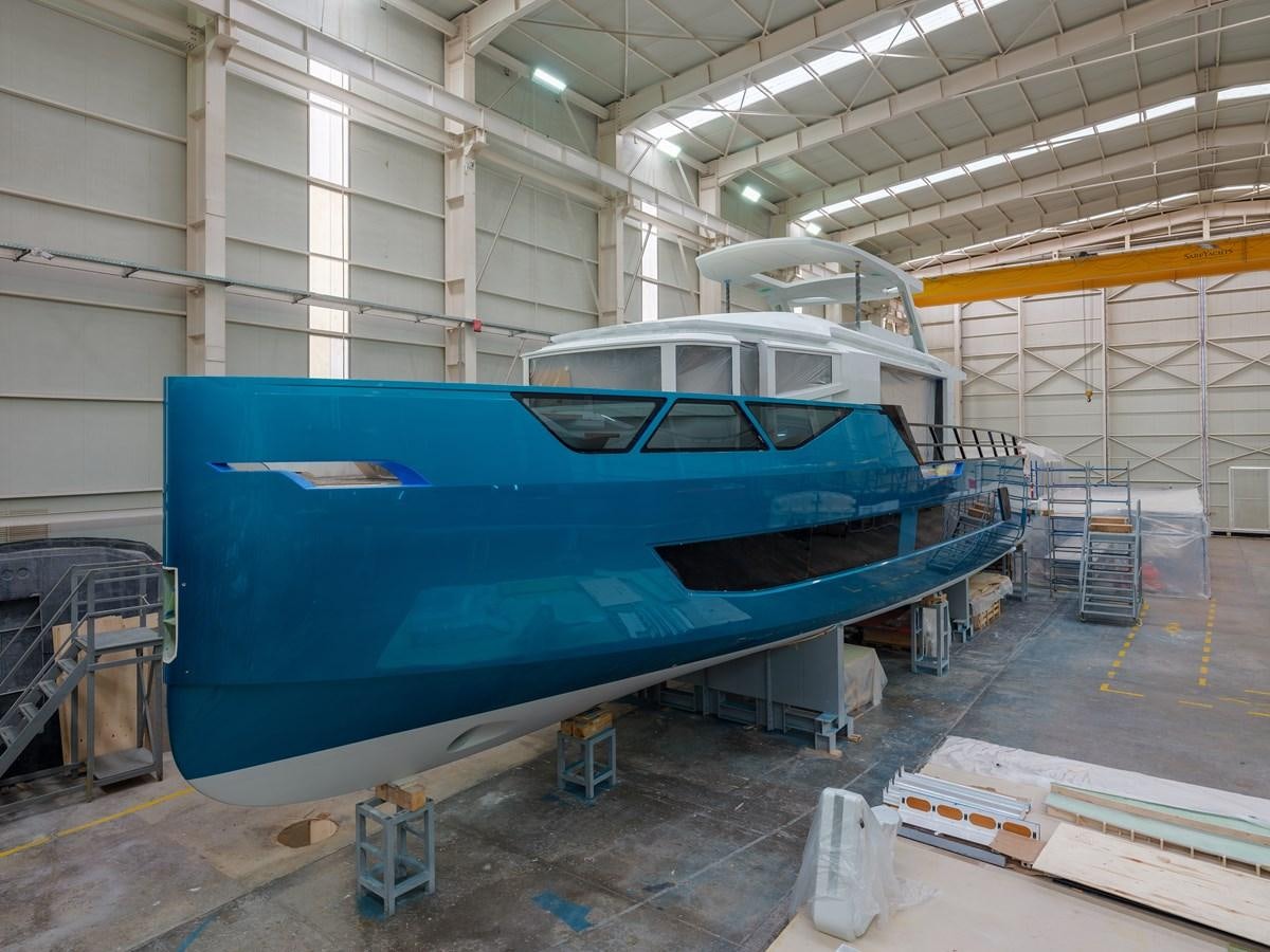 a large blue airplane in a warehouse aboard EDGE - XSR 85 #NB201 Yacht for Sale