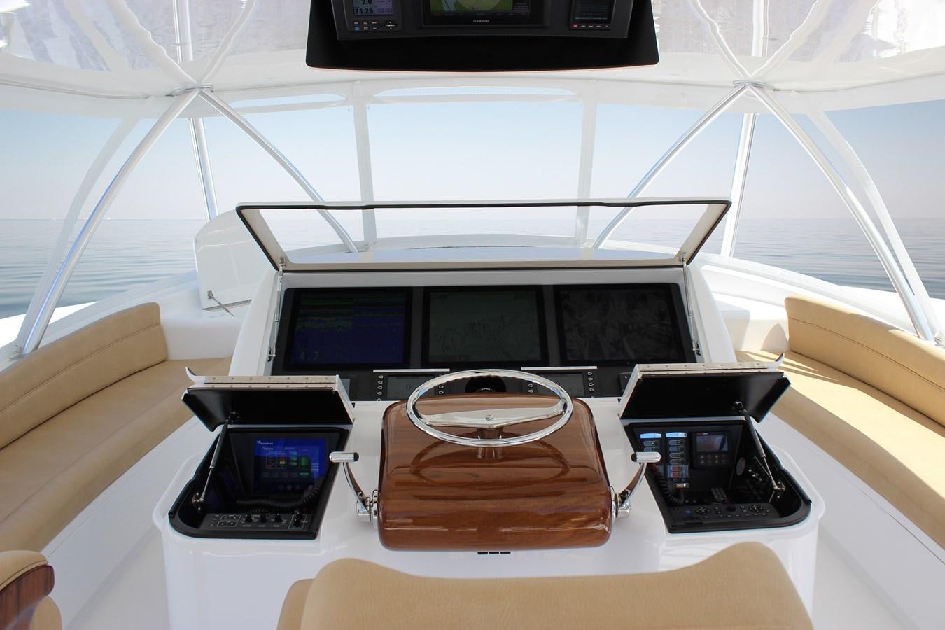 a group of electronic devices on a table aboard NEW VIKING 72 CONVERTIBLE Yacht for Sale