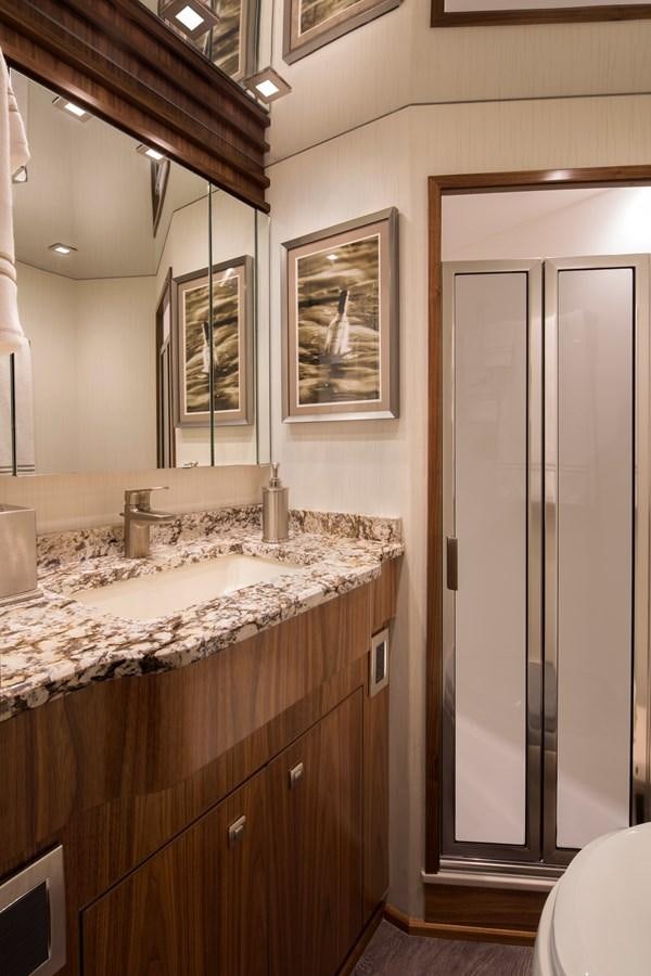 a bathroom with a sink and a mirror aboard NEW VIKING 72 CONVERTIBLE Yacht for Sale
