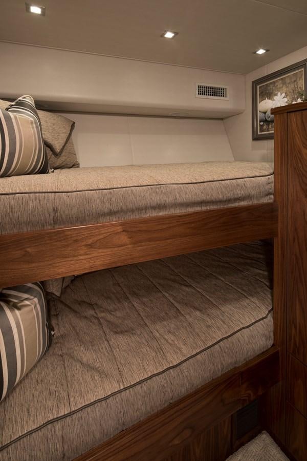 a bed with a wooden headboard aboard NEW VIKING 72 CONVERTIBLE Yacht for Sale