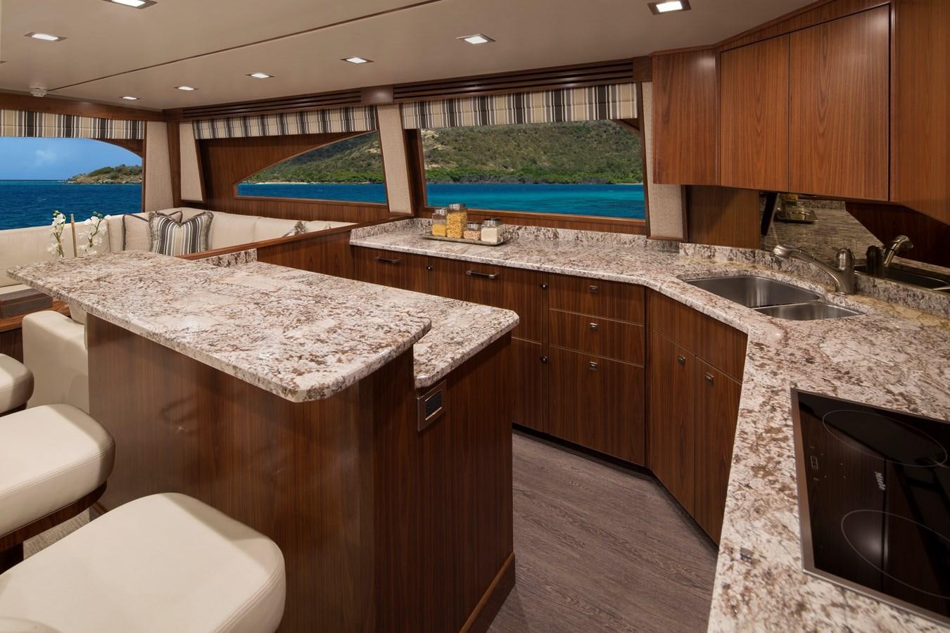 a kitchen with a large island aboard NEW VIKING 72 CONVERTIBLE Yacht for Sale