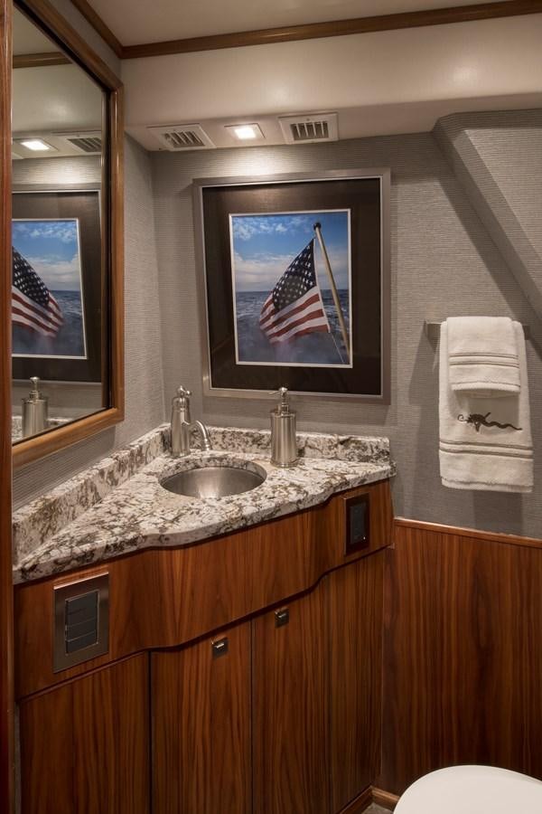 a bathroom with a sink and a mirror aboard NEW VIKING 72 CONVERTIBLE Yacht for Sale