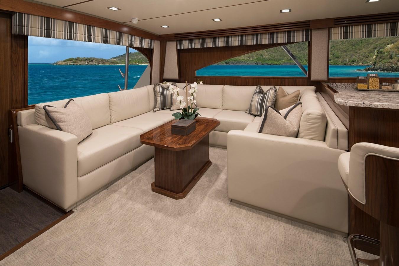 a living room with a couch and a table aboard NEW VIKING 72 CONVERTIBLE Yacht for Sale