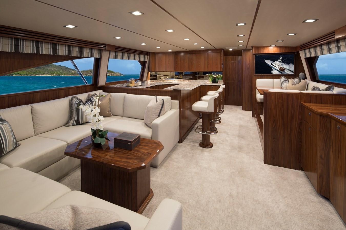 a living room with a couch and a coffee table aboard NEW VIKING 72 CONVERTIBLE Yacht for Sale
