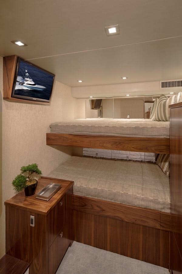 a room with a few beds aboard NEW VIKING 72 CONVERTIBLE Yacht for Sale