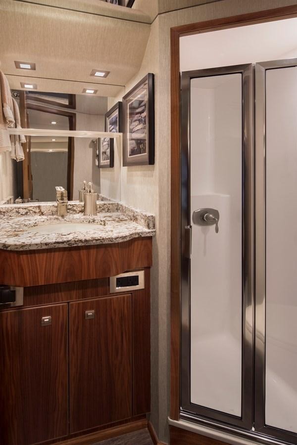 a bathroom with a sink and a mirror aboard NEW VIKING 72 CONVERTIBLE Yacht for Sale