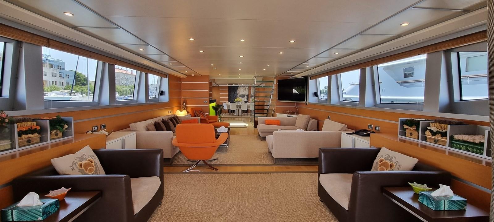 a living room with a couch and a tv aboard CHOO CHOO Yacht for Sale