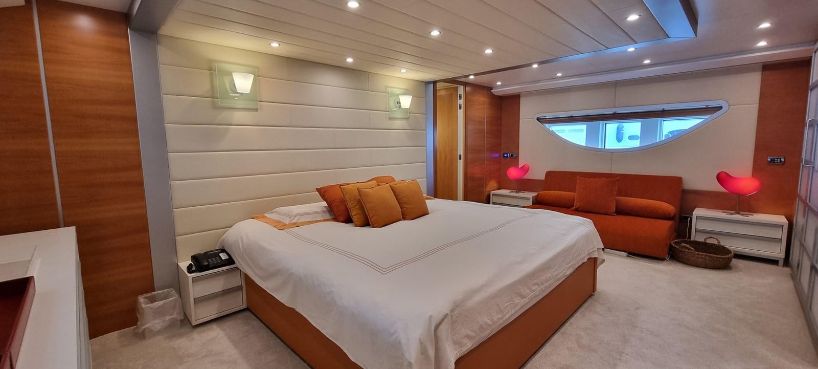 a room with a bed and a couch aboard CHOO CHOO Yacht for Sale
