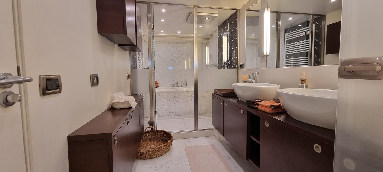 a bathroom with a sink and a mirror aboard CHOO CHOO Yacht for Sale