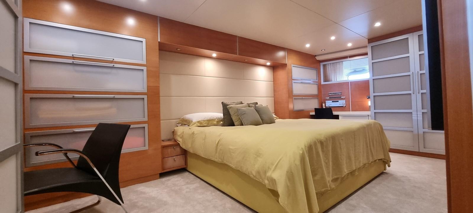 a bedroom with a bed and a desk aboard CHOO CHOO Yacht for Sale