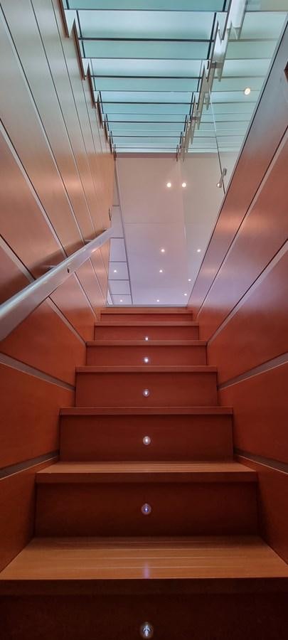 a red staircase with a glass ceiling aboard CHOO CHOO Yacht for Sale