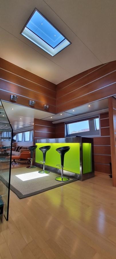 a room with a tv and a table aboard CHOO CHOO Yacht for Sale