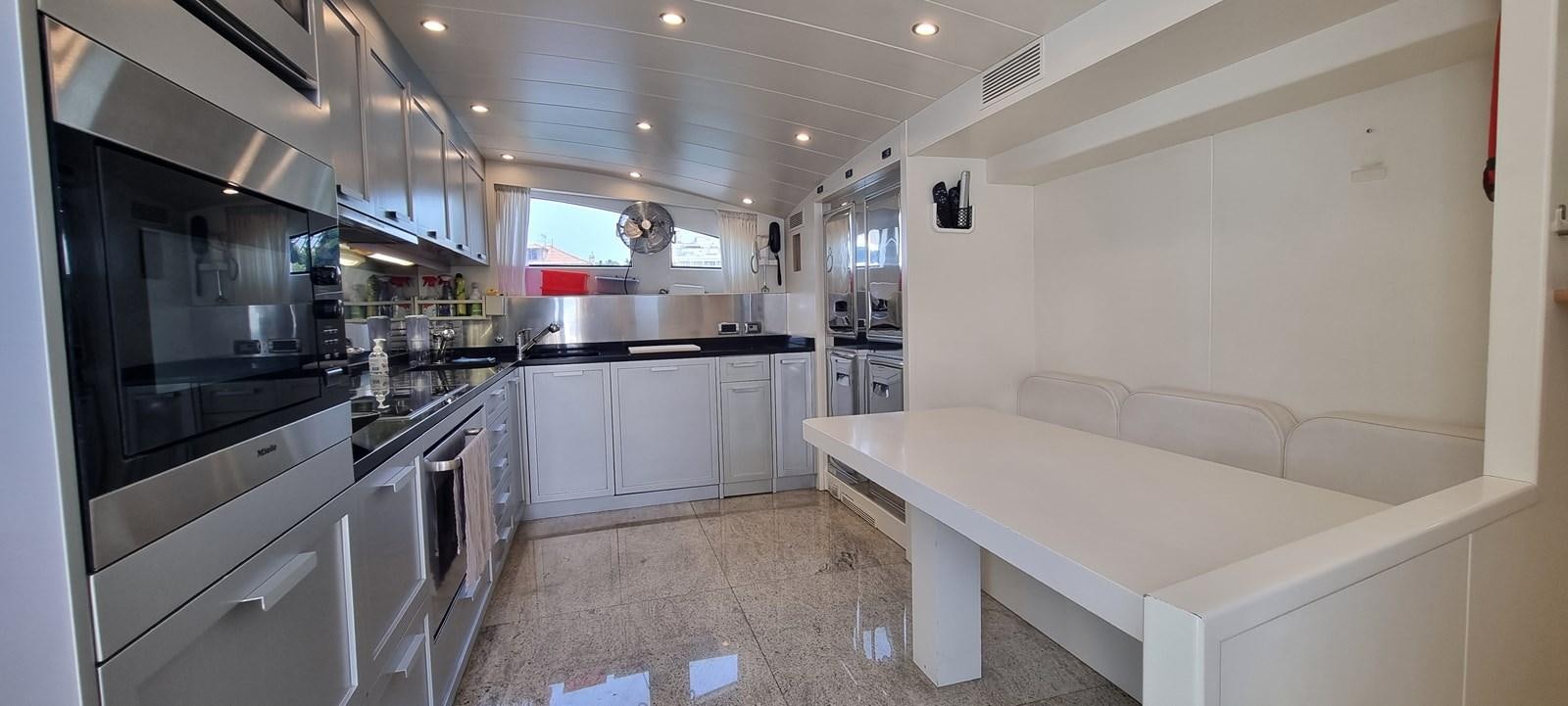 a kitchen with a large island aboard CHOO CHOO Yacht for Sale
