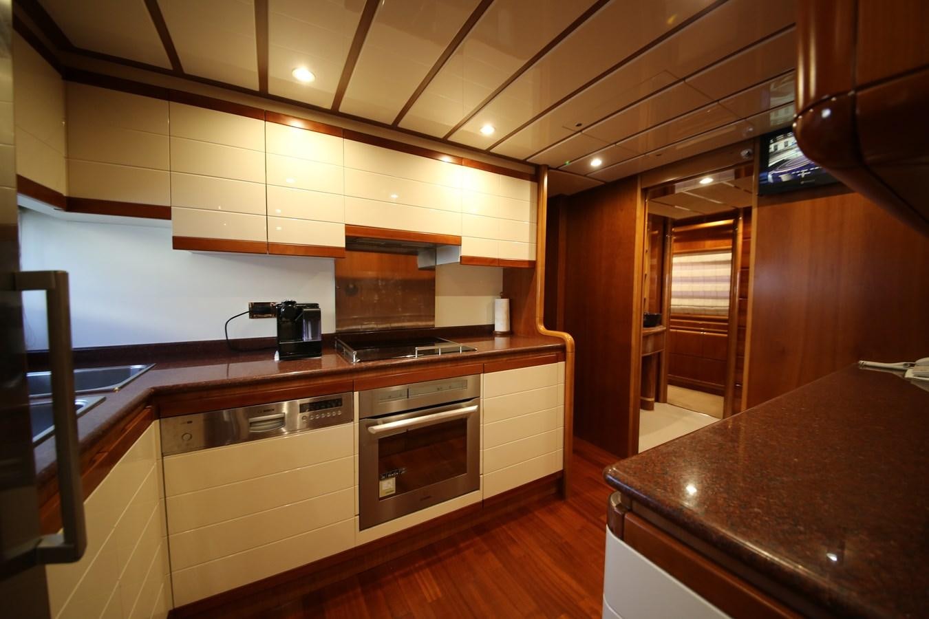 a kitchen with a stove and cabinets aboard YOLO TOO Yacht for Sale