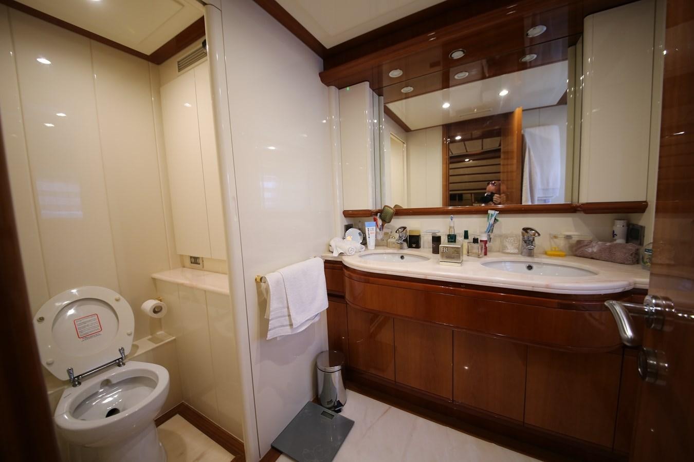a bathroom with a toilet and a sink aboard YOLO TOO Yacht for Sale