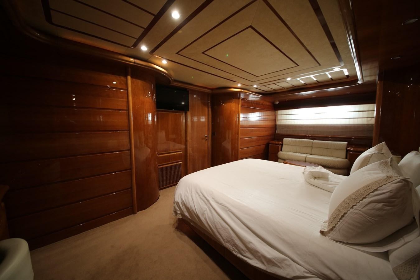 a room with a bed and a television aboard YOLO TOO Yacht for Sale