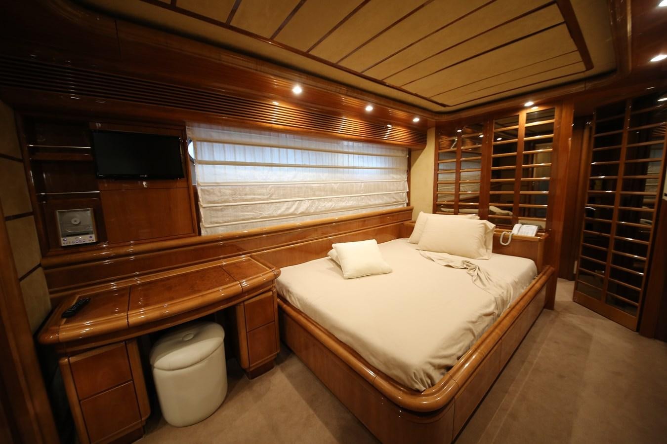 a room with a bed and a television aboard YOLO TOO Yacht for Sale