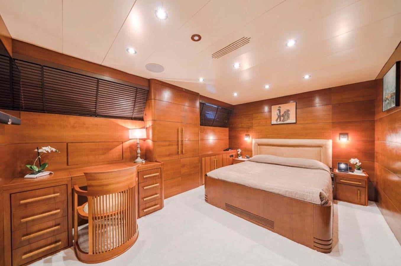 a room with a bed and a chair aboard FIORENTE Yacht for Charter