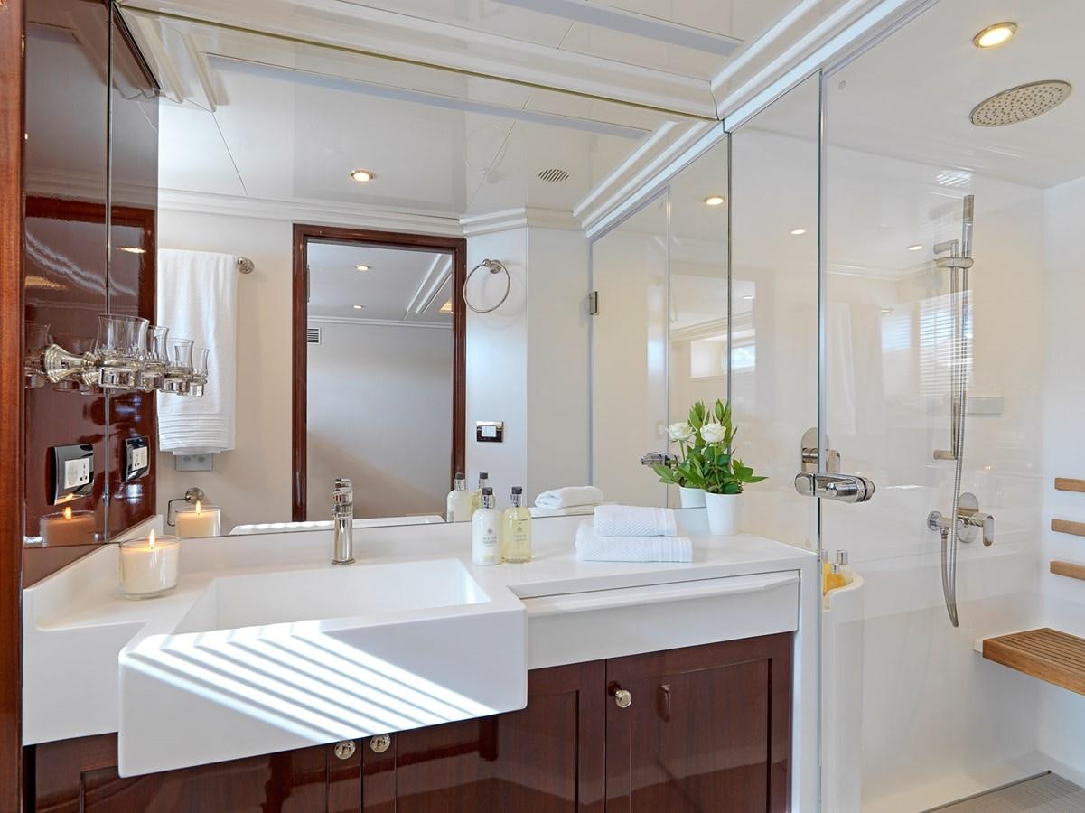 a bathroom with a glass shower aboard MIA ZOI Yacht for Sale
