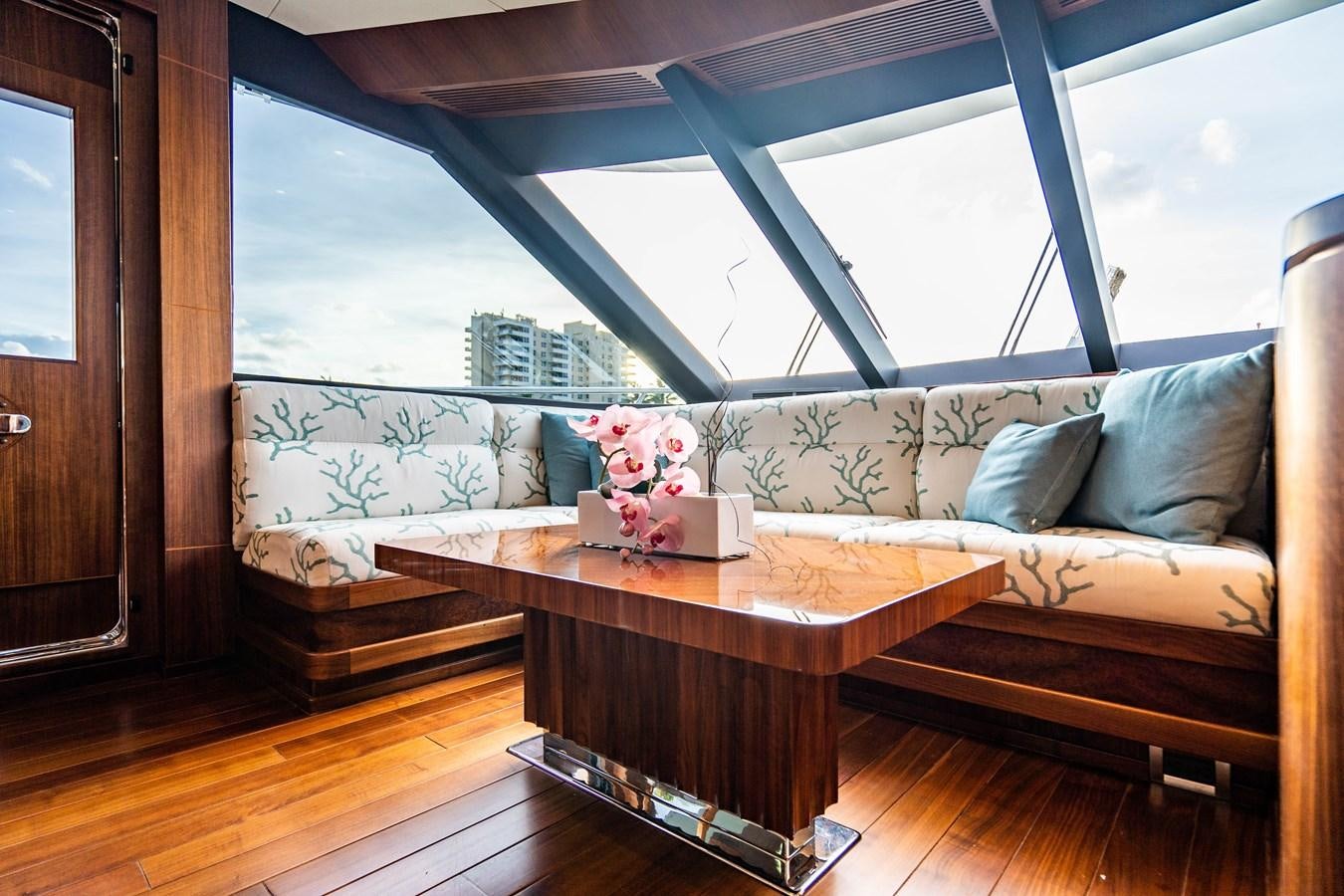 a living room with a couch and a table aboard PICO Yacht for Sale