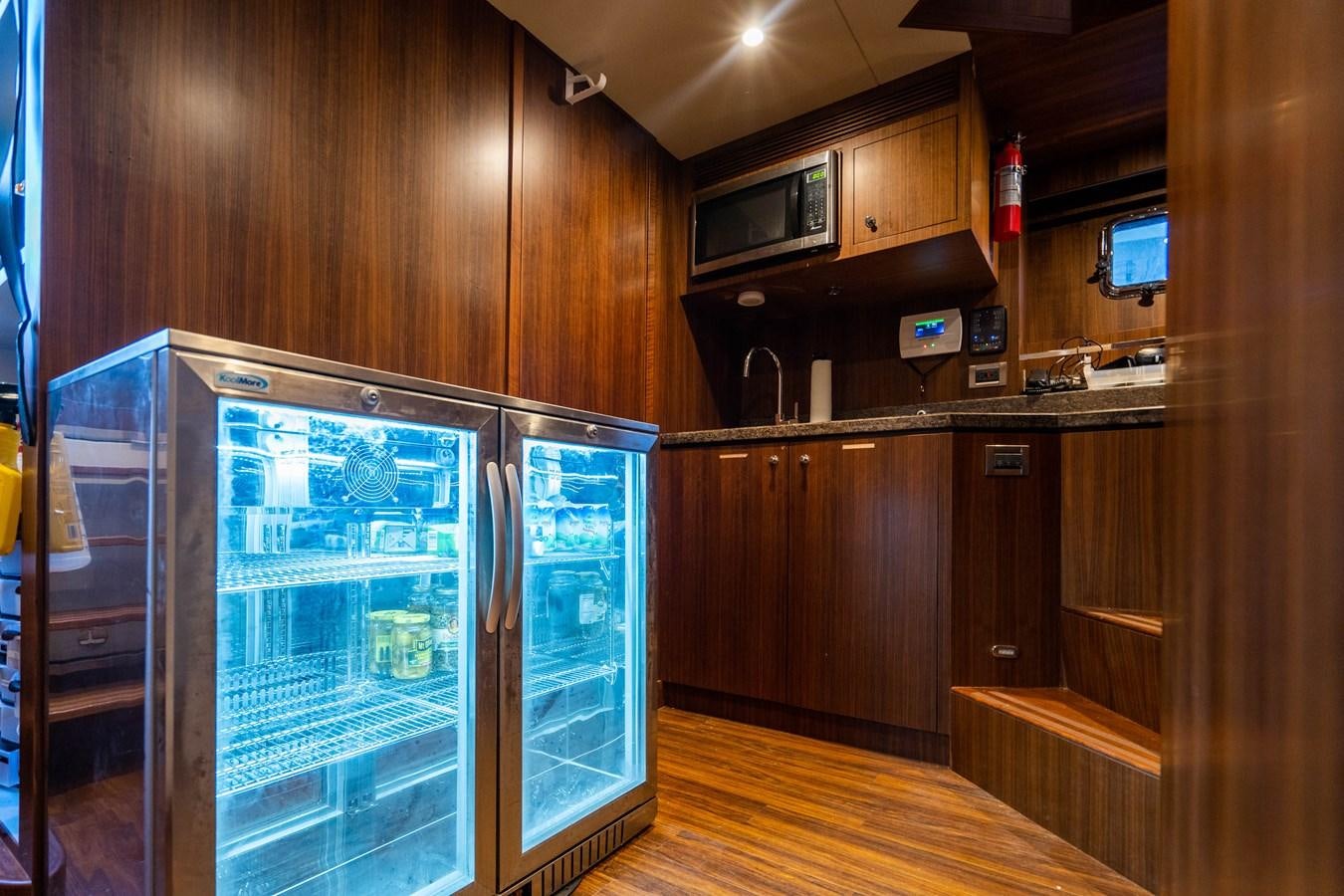 a kitchen with wooden cabinets aboard PICO Yacht for Sale