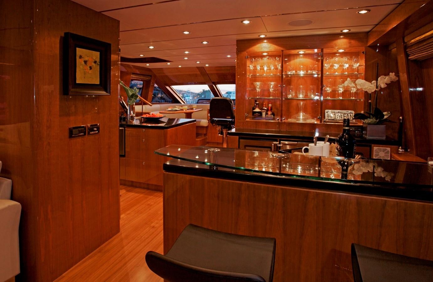 a bar with a counter and chairs aboard LADY C II Yacht for Sale