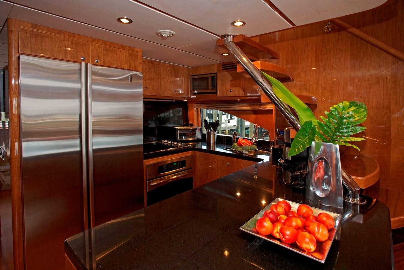 a kitchen with a large refrigerator and a glass of wine aboard LADY C II Yacht for Sale