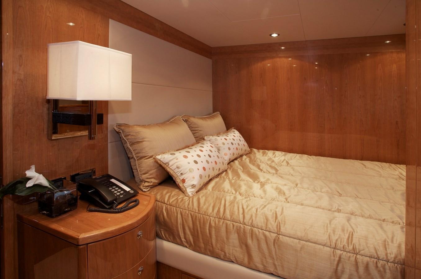a hotel room with a bed and a phone aboard LADY C II Yacht for Sale