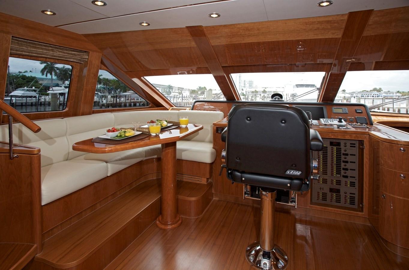 a table and chairs in a room aboard LADY C II Yacht for Sale