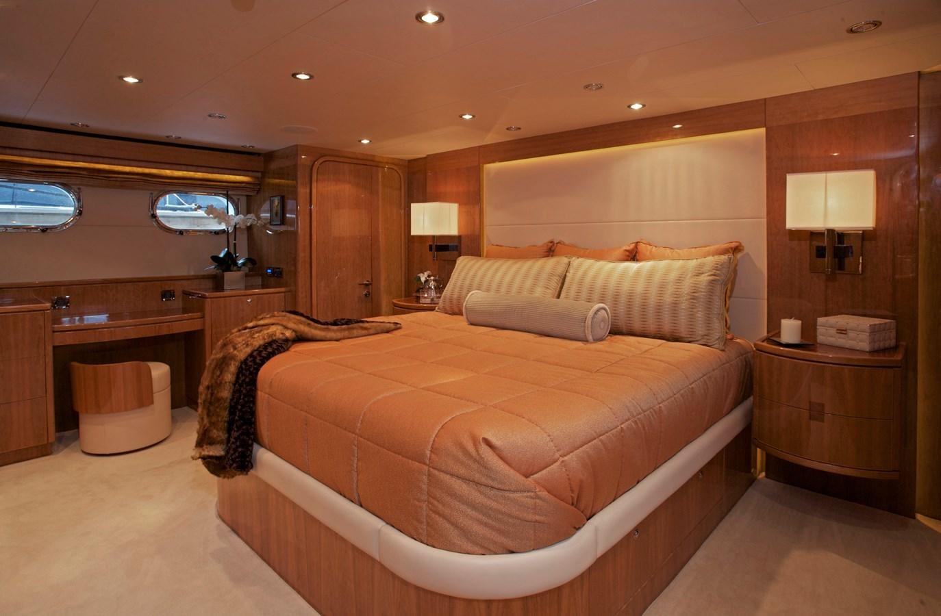 a bedroom with a bed and a desk aboard LADY C II Yacht for Sale