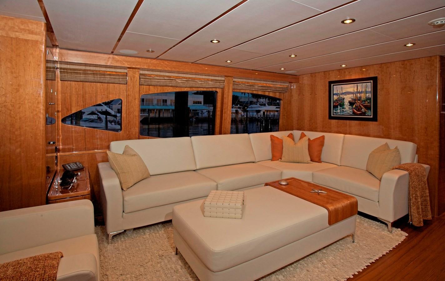 a living room with a couch and a table aboard LADY C II Yacht for Sale