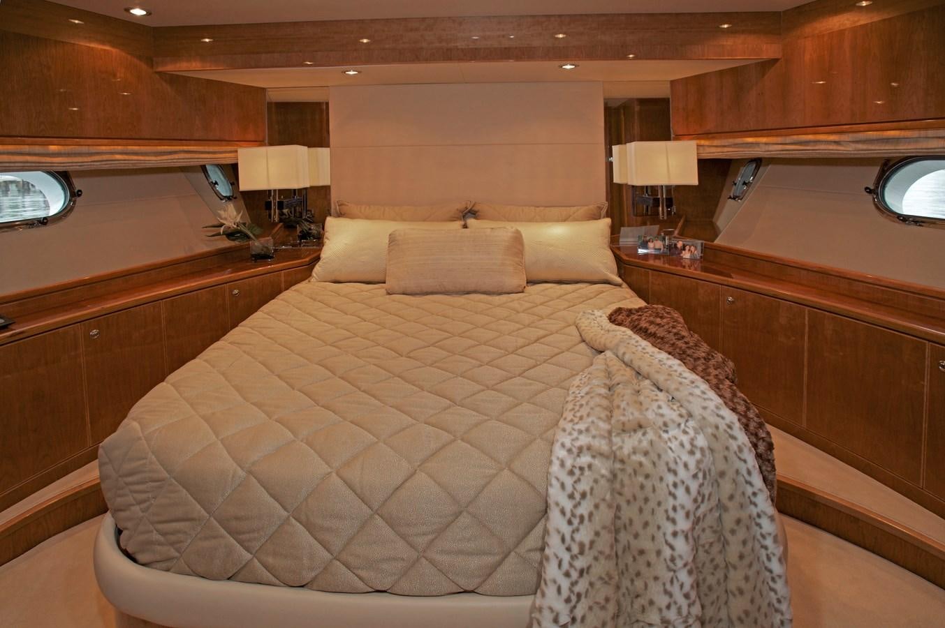 a hotel room with a bed and a chair aboard LADY C II Yacht for Sale